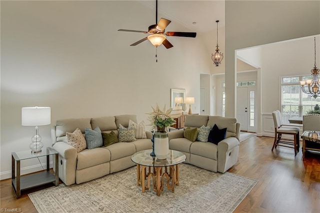 3001 Walbrook Ter, Browns Summit, NC 27214 - living area featuring a chandelier, high vaulted ceiling, a ceiling fan, and wood finished floors