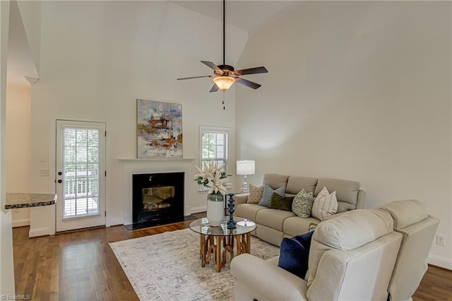 3001 Walbrook Ter, Browns Summit, NC 27214 - living room with plenty of natural light, a ceiling fan, high vaulted ceiling, a fireplace with flush hearth, and dark wood-style floors