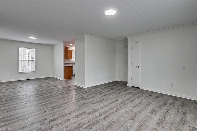 unfurnished living room with crown molding and light wood-type flooring