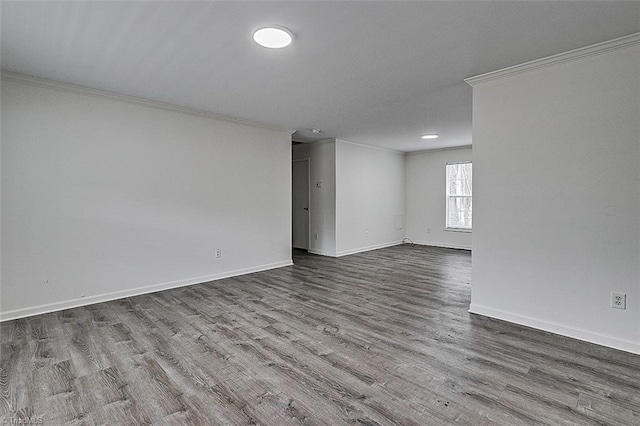 spare room with crown molding and hardwood / wood-style floors