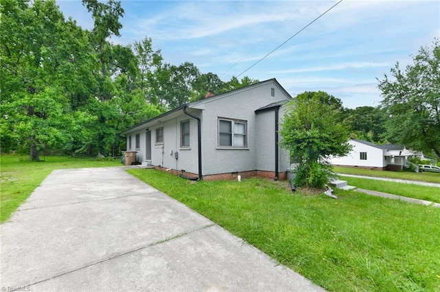 1017 Logan St Unit 2, Greensboro, NC 27406 - ranch-style home with a front lawn, stucco siding, driveway, and view of scattered trees