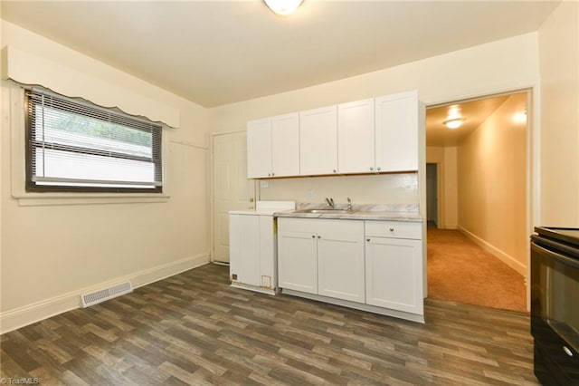 1017 Logan St Unit 2, Greensboro, NC 27406 - kitchen with stove, a sink, light countertops, baseboards, and dark wood finished floors