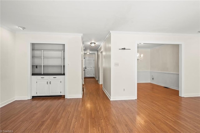 4548 Fernhaven Cir, Winston-Salem, NC 27104 - spare room with wood finished floors, crown molding, baseboards, built in features, and a chandelier
