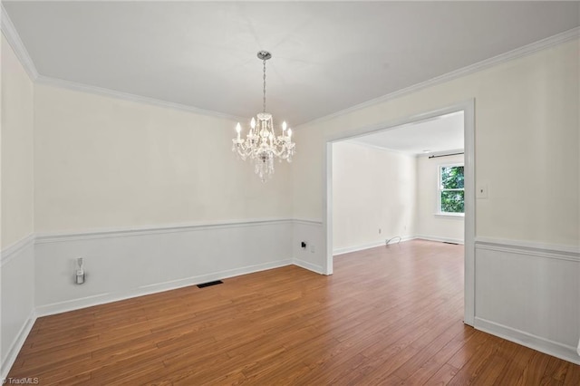 4548 Fernhaven Cir, Winston-Salem, NC 27104 - spare room featuring a chandelier, hardwood / wood-style flooring, and crown molding
