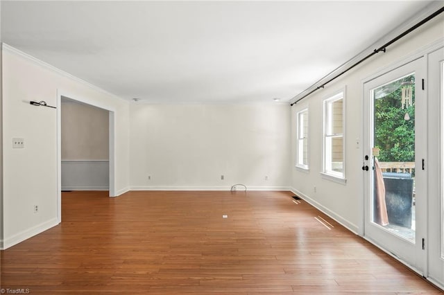 4548 Fernhaven Cir, Winston-Salem, NC 27104 - unfurnished room with light wood-style floors, baseboards, and crown molding