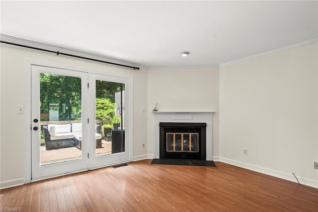 4548 Fernhaven Cir, Winston-Salem, NC 27104 - unfurnished living room featuring wood finished floors, baseboards, ornamental molding, and a fireplace with flush hearth