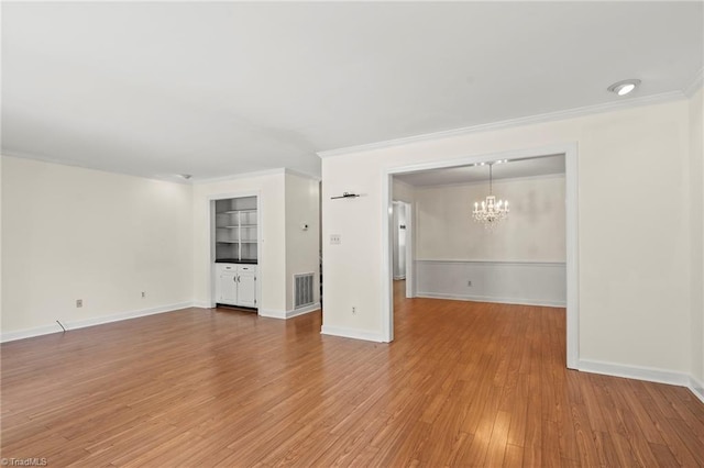 4548 Fernhaven Cir, Winston-Salem, NC 27104 - unfurnished room featuring a chandelier, crown molding, wood finished floors, and baseboards