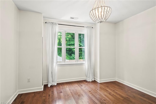 4548 Fernhaven Cir, Winston-Salem, NC 27104 - spare room featuring a chandelier, hardwood / wood-style flooring, and baseboards
