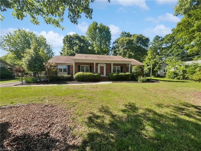 single story home featuring a front yard and brick siding