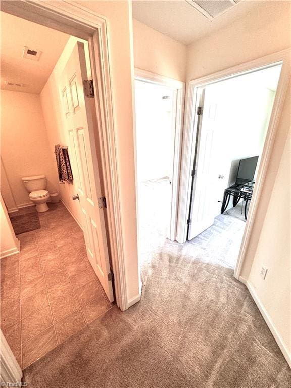 7213 Olmstead Dr, Burlington, NC 27215 - hallway with light carpet and baseboards