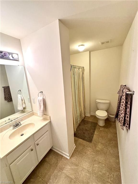 7213 Olmstead Dr, Burlington, NC 27215 - bathroom with toilet, vanity, tile patterned flooring, and a shower with curtain