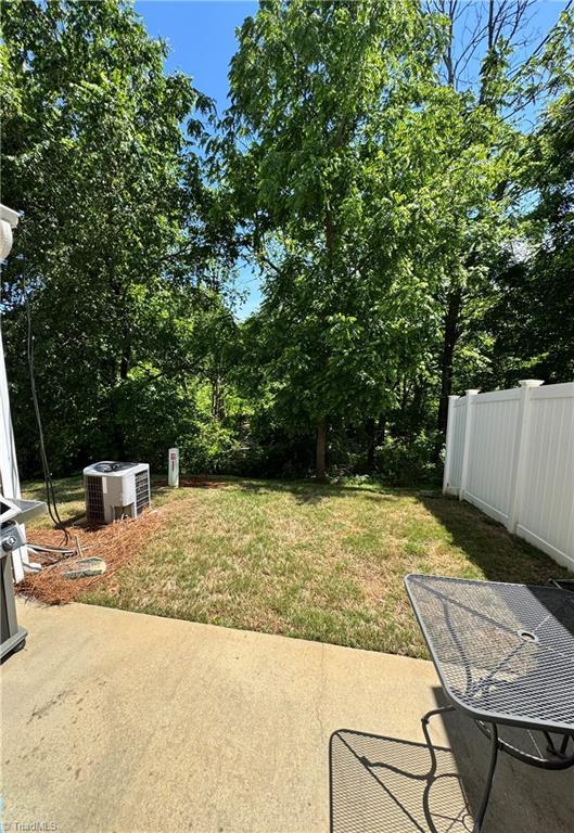7213 Olmstead Dr, Burlington, NC 27215 - view of yard with a patio area, central AC, and view of scattered trees