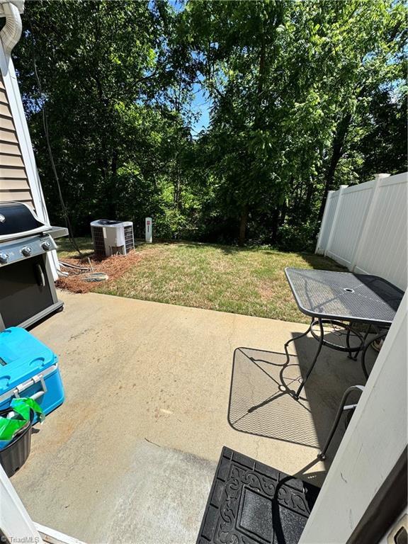 7213 Olmstead Dr, Burlington, NC 27215 - view of patio with cooling unit, grilling area, outdoor dining area, and view of scattered trees