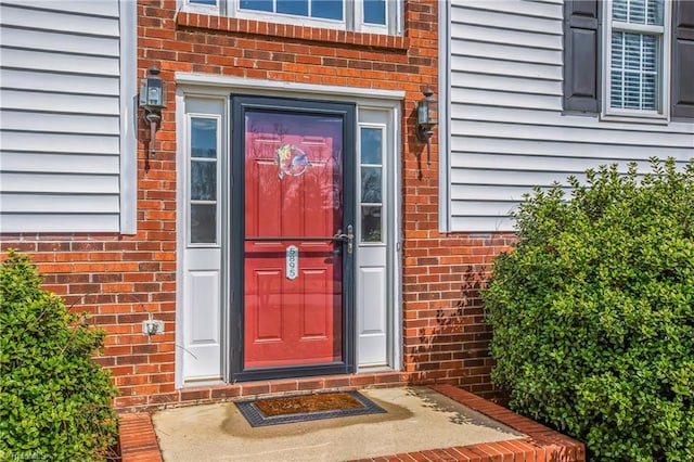 property entrance with brick siding