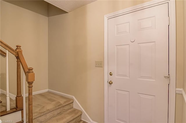 interior space featuring carpet floors and a textured ceiling