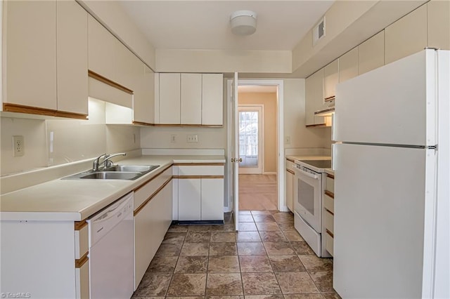 kitchen with sink, white cabinets, and white appliances