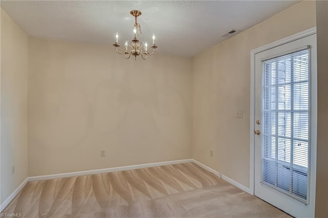 interior space with light colored carpet, a notable chandelier, and a wealth of natural light