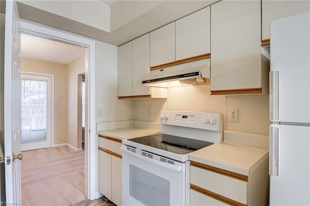 kitchen featuring white cabinetry, light colored carpet, and white appliances