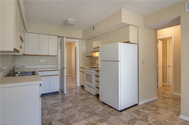 kitchen featuring white appliances, sink, and white cabinets