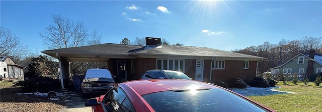 view of front of property featuring a carport and a front lawn