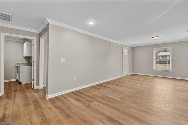 unfurnished room with light hardwood / wood-style flooring and ornamental molding