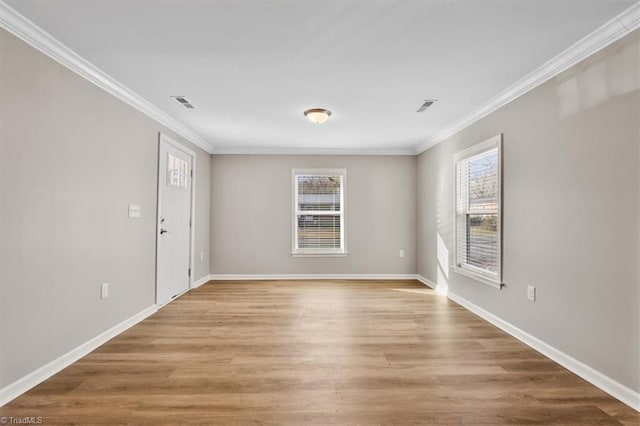 unfurnished room with ornamental molding and hardwood / wood-style floors