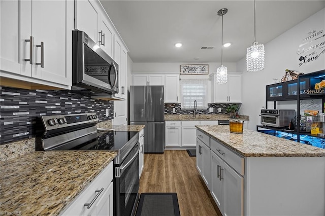 817 Sagemount St, Jamestown, NC 27282 - kitchen with appliances with stainless steel finishes, dark wood-type flooring, white cabinetry, tasteful backsplash, and recessed lighting