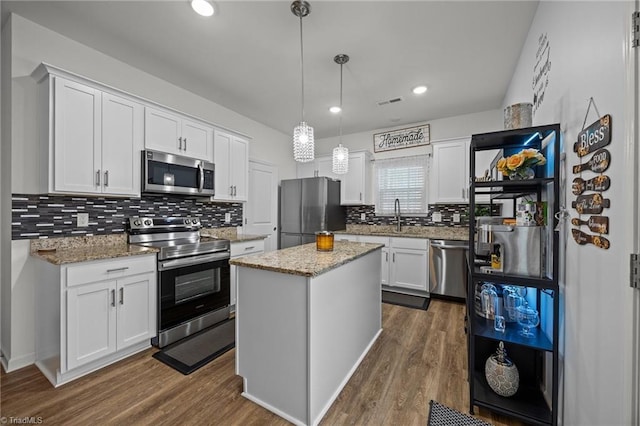 817 Sagemount St, Jamestown, NC 27282 - kitchen with appliances with stainless steel finishes, dark wood-type flooring, white cabinetry, backsplash, and recessed lighting