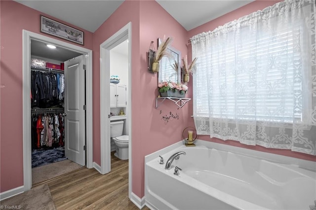 817 Sagemount St, Jamestown, NC 27282 - full bath featuring a garden tub, toilet, wood finished floors, a walk in closet, and baseboards