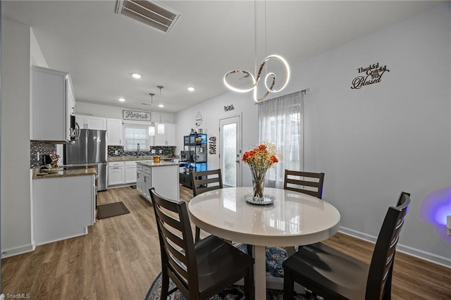 817 Sagemount St, Jamestown, NC 27282 - dining area featuring wood finished floors, recessed lighting, a chandelier, and baseboards