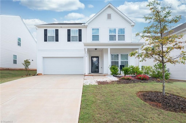 traditional-style home with an attached garage, driveway, and a front yard