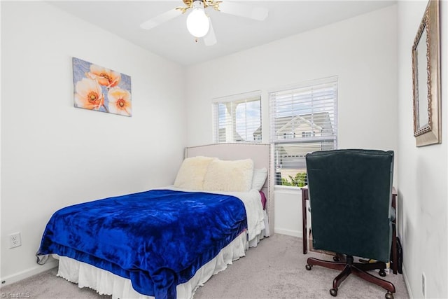 carpeted bedroom with baseboards and ceiling fan