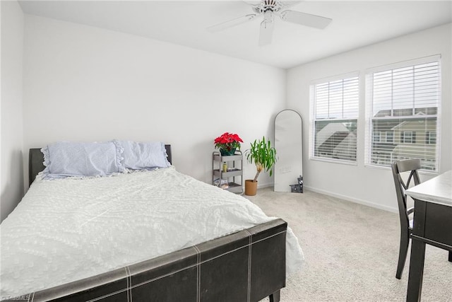 carpeted bedroom with baseboards and ceiling fan