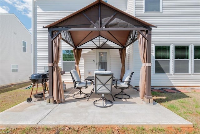 view of patio featuring a gazebo, outdoor dining space, and a grill