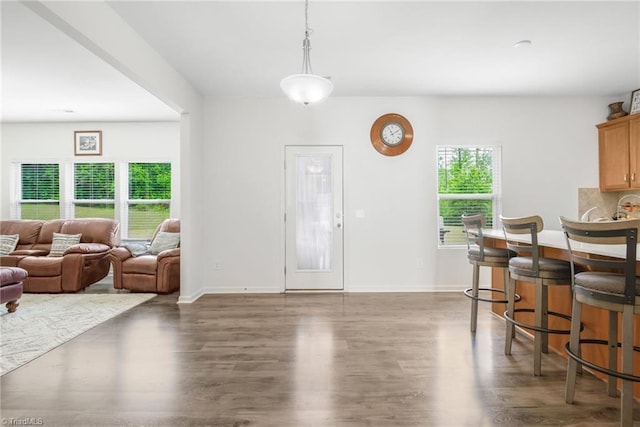 dining space with wood finished floors and baseboards
