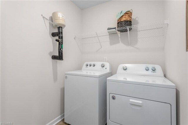 clothes washing area with washing machine and dryer