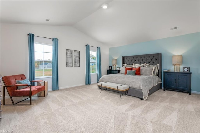 bedroom featuring light colored carpet and vaulted ceiling