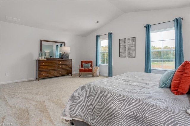 carpeted bedroom with multiple windows and lofted ceiling