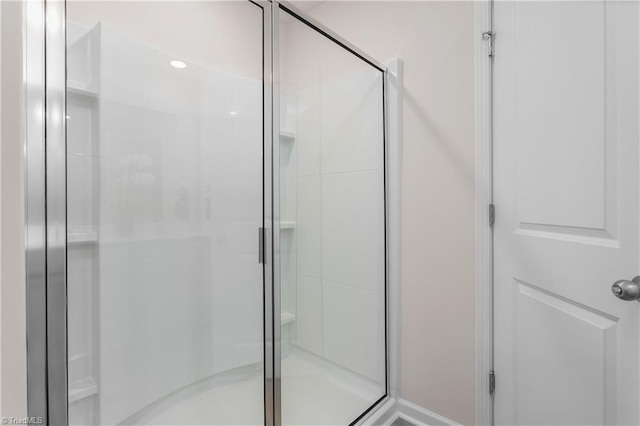 bathroom featuring a shower with shower door