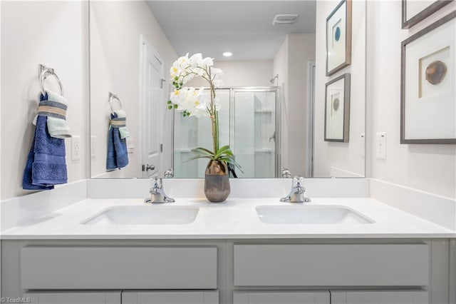 bathroom with vanity and a shower with shower door