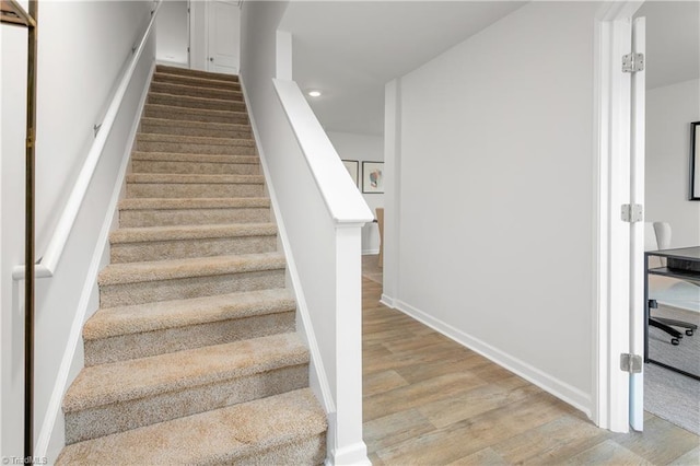 staircase with hardwood / wood-style floors