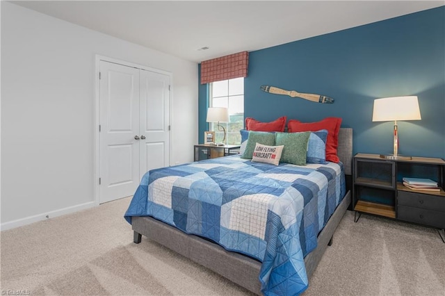 carpeted bedroom with a closet