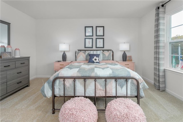 bedroom featuring light carpet