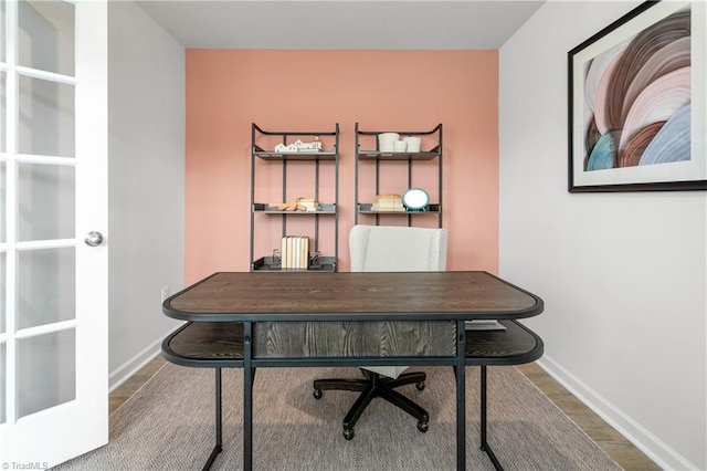 home office with wood-type flooring