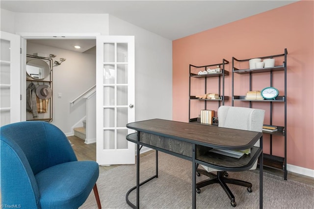 office with wood-type flooring and french doors