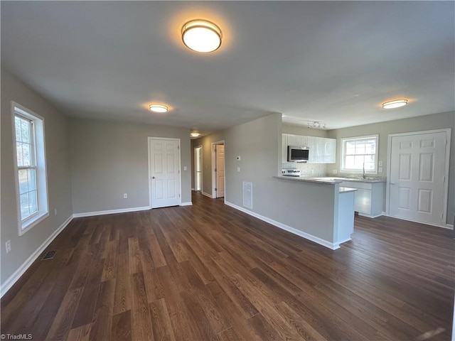 unfurnished living room featuring dark hardwood / wood-style flooring