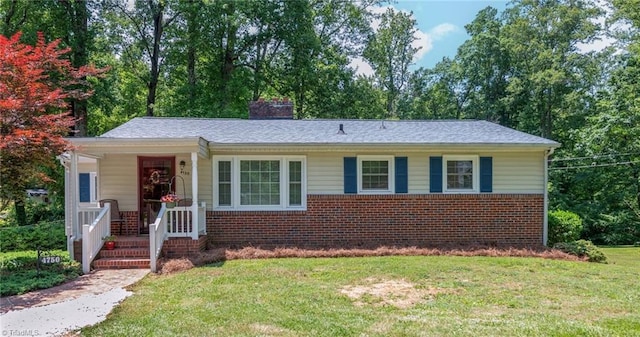 4750 Carlton Dr, Winston-Salem, NC 27105 - bungalow-style home with brick siding, a front lawn, and a chimney
