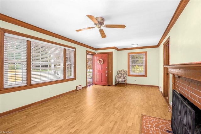 4750 Carlton Dr, Winston-Salem, NC 27105 - unfurnished living room with light wood finished floors, a brick fireplace, crown molding, baseboards, and a ceiling fan