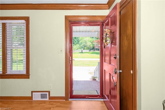 4750 Carlton Dr, Winston-Salem, NC 27105 - entryway featuring crown molding, plenty of natural light, baseboards, and light wood-style flooring