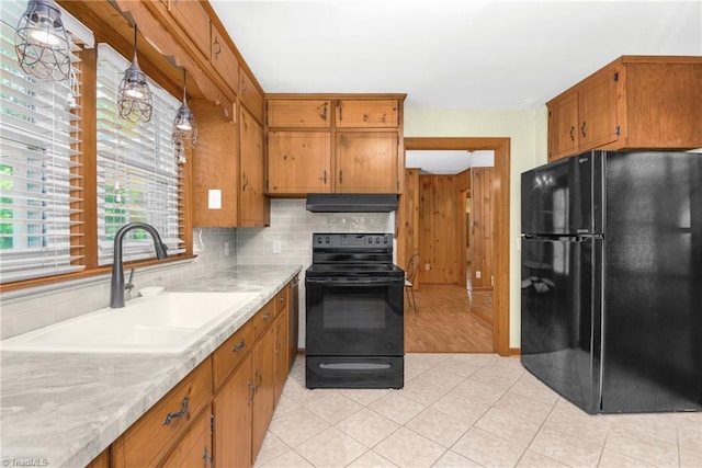 4750 Carlton Dr, Winston-Salem, NC 27105 - kitchen featuring black appliances, a sink, exhaust hood, and brown cabinetry